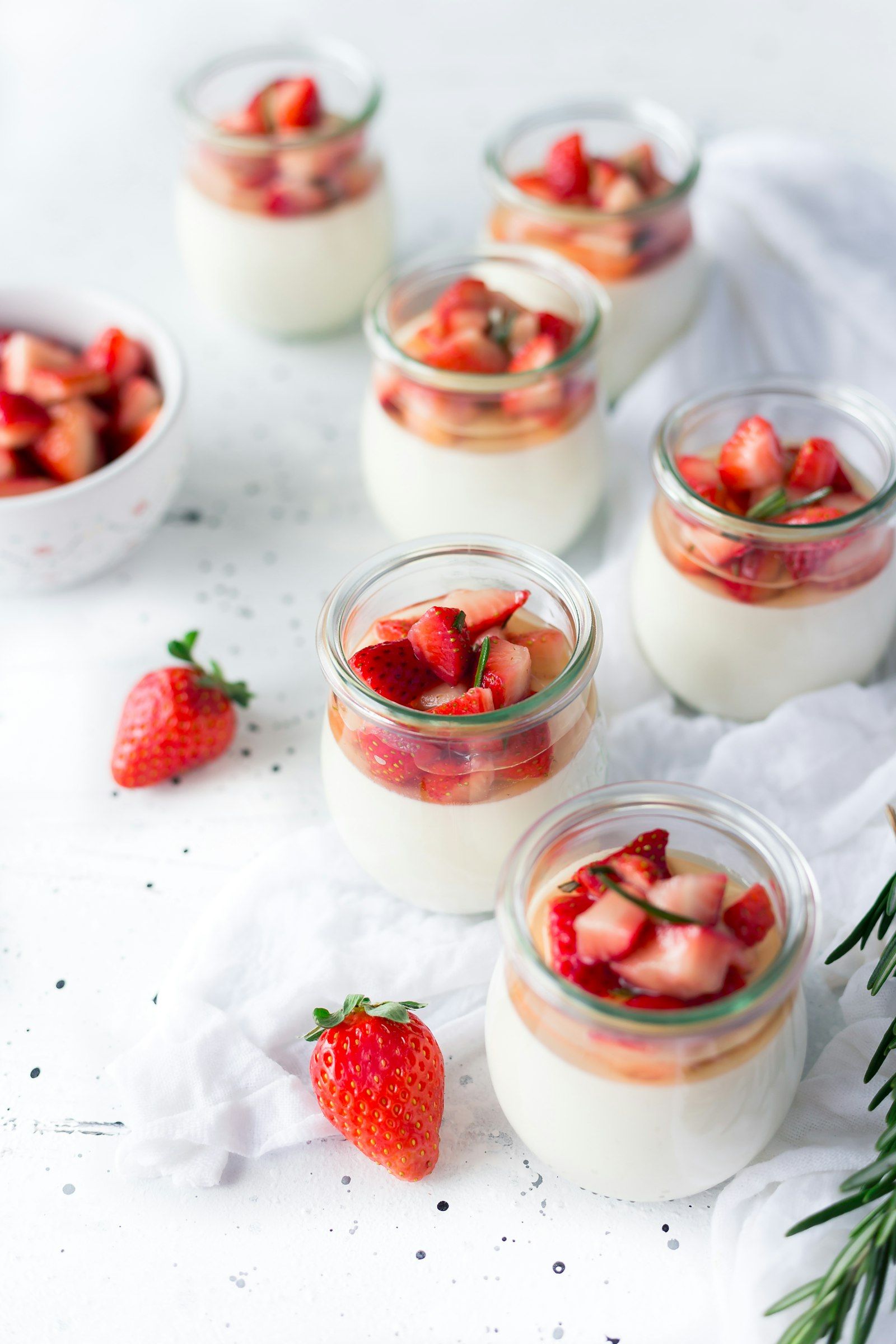 A tall glass parfait layered with Greek yogurt, granola, and fresh berries.
